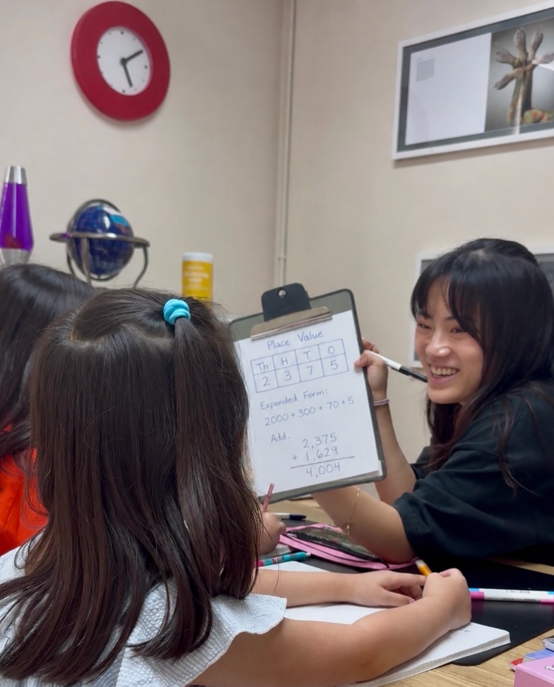 Math Leap — Ms. Ji teaching place value with a young student